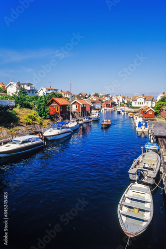 Idyllic old swedish fishing village with boats in a canal