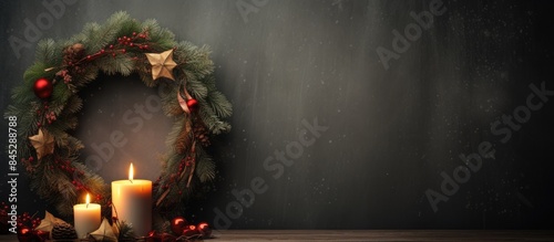 A cozy Christmas composition featuring a candle holder and a wreath displayed on the wall creating a warm and festive atmosphere Perfect for a copy space image 142 characters