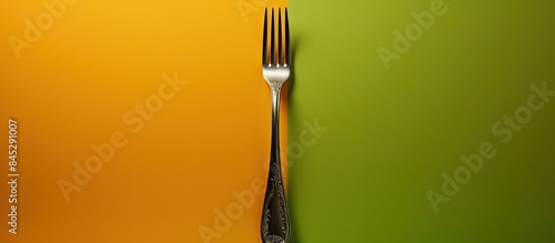 A fork securely encased by a measuring tape portraying the idea of monitoring food consumption for dieting and weight reduction Copy space image
