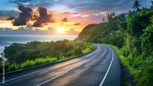 Empty highway, dense tropical forest on one side of the road and sea coast on the other, , sky illuminated by the sun's rays at sunset, incredible nature