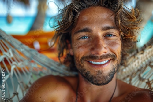 Detailed close-up of a beaming man with curly hair relaxing in a hammock, evoking a sense of leisure and happiness