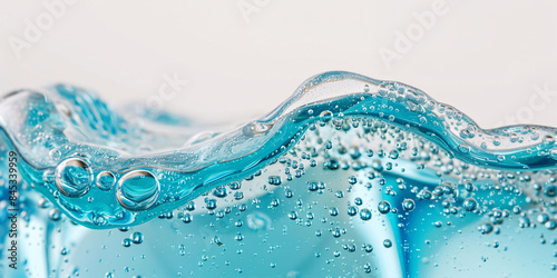 Close-up texture of blue cosmetic gel, macrophotography of facial serum with air bubbles.