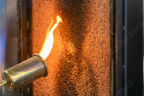 Close up of a flame torch testing flame retardant material, demonstrating fire resistance and safety