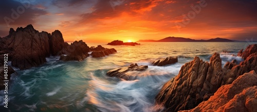 perfect sunset with sharp rocky seashore amazing seascape. Creative banner. Copyspace image