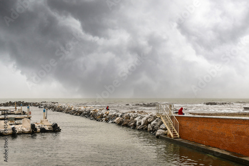 View of the mouth of the Brugiano River with the rocky pier during a spring storm, Massa Marittima, Massa Carrara, Tuscany, Italy