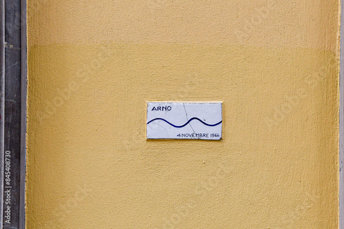 Ceramic plaque indicating the height reached by the Arno River during the devastating flood of 4th November 1966 on a building in Via de Tornabuoni, Florence, Tuscany, Italy