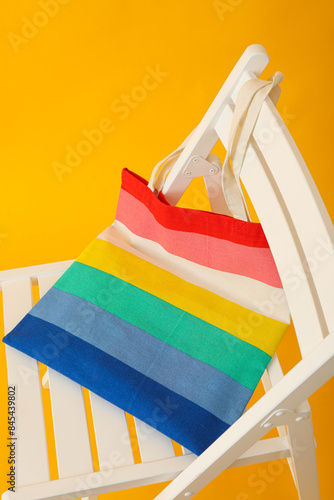 Concept of lgbt parade, rainbow shopper, on color background.