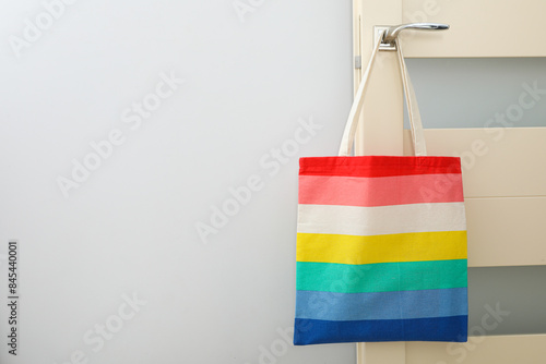 Concept of lgbt parade, rainbow shopper, on color background.