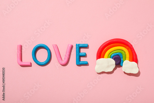 LGBT parade concept, holiday symbols on pink background.