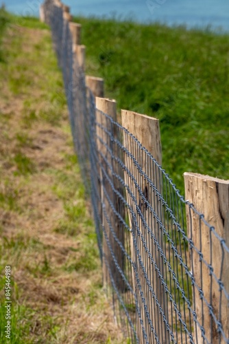 fence at steep coast at cap blanc nez france