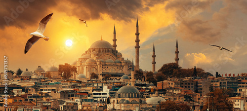 Beautiful view of gorgeous historical Suleymaniye Mosque, Rustem Pasa Mosque and buildings in front of dramatic sunset. Istanbul most popular tourism destination of Turkey. Travel Turkey concept. 