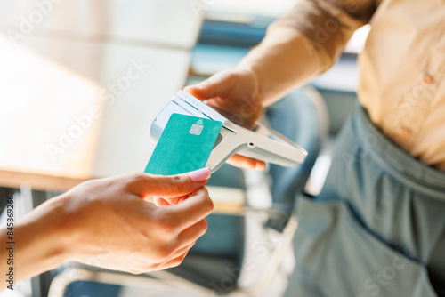 NFC credit card payment. Woman paying with contactless credit card with NFC