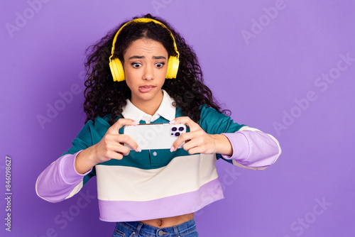 Photo of nice young girl play game smart phone wear shirt isolated on violet color background