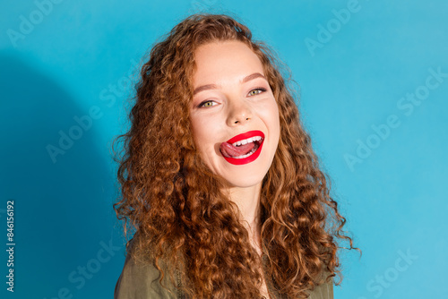Portrait of pretty young woman tongue lick lips wear khaki shirt isolated on turquoise color background