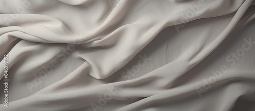 An artistic grey wale linen canvas acts as the background for a mock up template of a cream abstract cotton towel This cloth can be used as a blanket curtain or for text decoration purposes