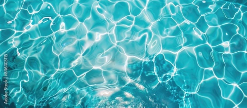 Abstract overhead view of empty swimming pool with crystal clear water surface and blue underwater pattern, devoid of any swimmers.