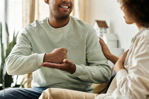 A couple in love, using sign language to communicate at home, showcasing the beauty of nonverbal expression.