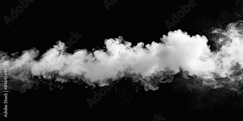 A white cloud is seen floating against a dark background in the air