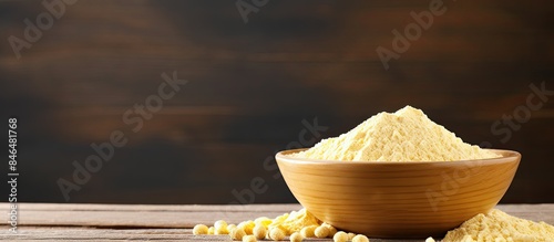 Copy space image of chickpea flour in a white ceramic bowl placed on a wooden table