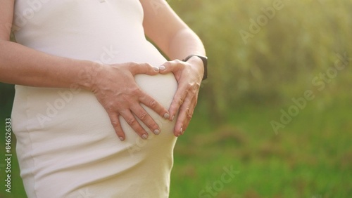 pregnant woman. a young mother is impatiently waiting for her child, hugging her belly. motherhood, pregnancy, happy family, kid lifestyle dream concept. a woman experiences maternal happiness