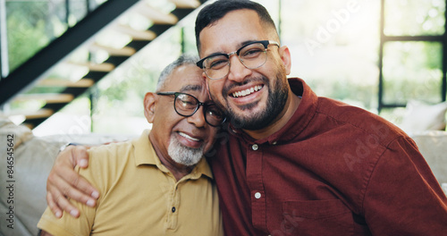 Smile, hug and man with senior father on sofa relaxing together for fathers day celebration. Happy, love and portrait of elderly male person embracing son for care and bonding in living room at home.