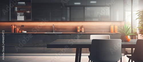 Blurry modern kitchen background with a desk space and striking furniture in a copy space image.