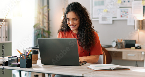 Research, smile and woman at desk with laptop, communication and update in office. Female journalist, typing and happy at computer for article, social media and contact in modern workplace in city