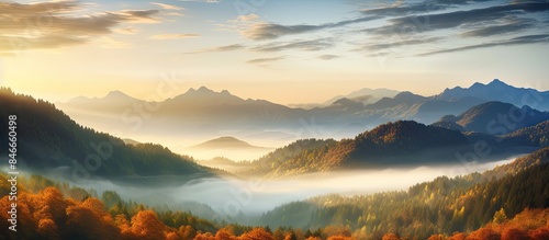 Beautiful sunrise over mountain forest in an autumn panoramic landscape with a mountain valley view at dawn, providing a picturesque copy space image.