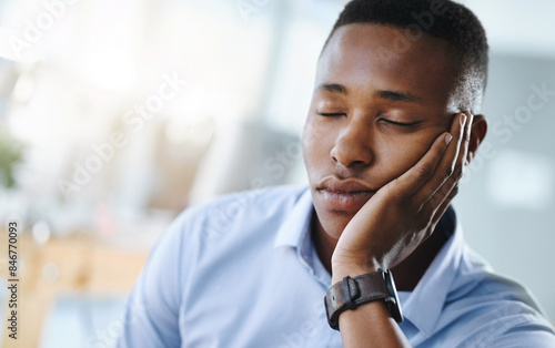Nap, relax or tired black man in office overwhelmed by deadlines with fatigue, face or burnout. Lazy worker, depressed consultant or exhausted professional resting or sleeping on hand in business
