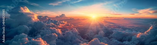 Expansive view of the sky with vibrant clouds and bright sunrise, capturing the beauty and tranquility of nature