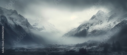 River meandering in front of snow-covered peaks enveloped in mist, creating a serene and mystical atmosphere. with copy space image. Place for adding text or design