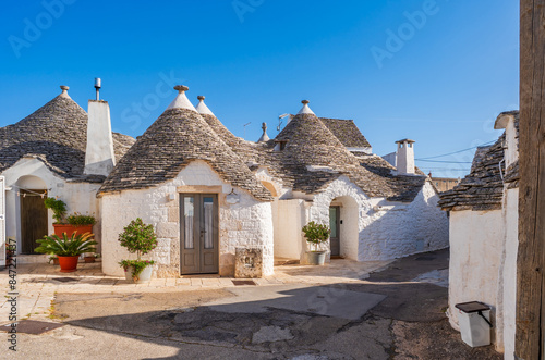 Famous traditional old dry stone trulli houses with conical roofs in Alberobello, Italy.