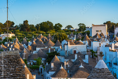 View of the famous old dry stone trulli houses with conical roofs in Alberobello. Italy
