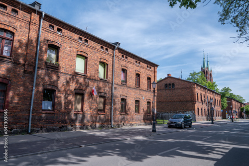 The characteristic red brick industrial buildings of the former textile factories in Żyrardów, Poland, stand as enduring symbols of the town's rich industrial heritage.