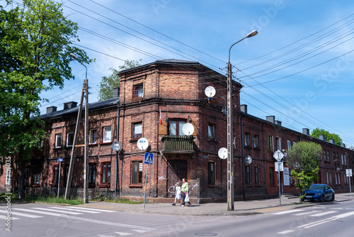 Characteristic red brick buildings in Żyrardów, Poland, have been repurposed into charming living spaces, blending historic industrial architecture with modern residential functionality.