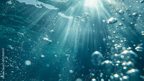 Underwater view with sunlight streaming through water and air bubbles.