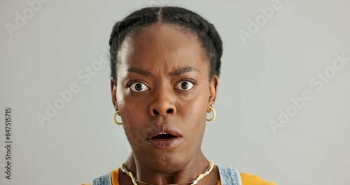 Shock, portrait and black woman in studio with wow for announcement, gossip or fake news on gray background. Wide eyes, omg and person with reaction for secret, wtf or unexpected revelation on mockup