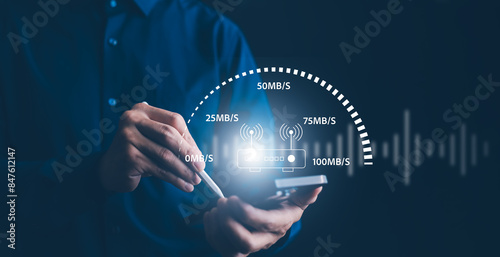 Fast internet connection with Metaverse technology concept, Hand holding smartphone and Virtual screen of Internet speed measurement,Internet and technology concept, 5G Hi speed internet concept