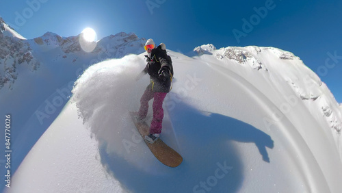 PORTRAIT, SELFIE: Woman with big smile spraying cloud of snow while snowboarding
