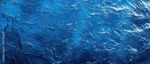 A close up shot of a blue water surface with rippling waves