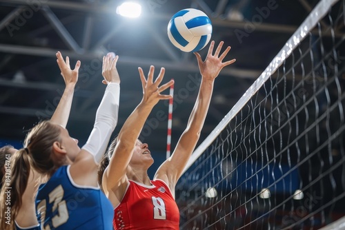 Players engaging in a competitive indoor volleyball match, leaping to block a spike