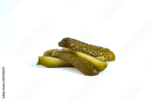 pile of cucumber dill pickle cut into spears, isolated on white background