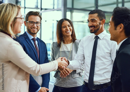 Group, business people and handshake for welcome, introduction or greeting in office. Shaking hands, smile and team with deal for collaboration, agreement or thank you for b2b partnership opportunity