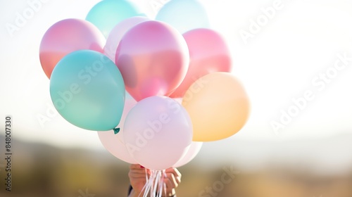 A Handful of Colorful Balloons Against a Sunny Sky