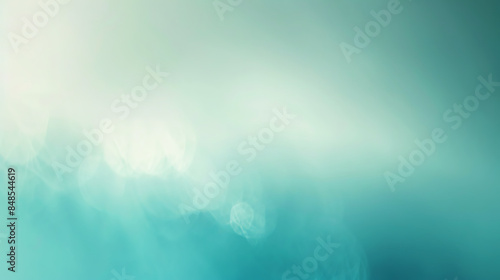 a blurred background with a gradient of colors ranging from light blue to teal. There are no distinct objects, text, or specific details visible in the image