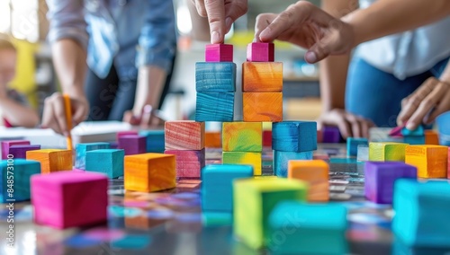 Business team using colorful blocks to build an artistic and creative cityscape on the table