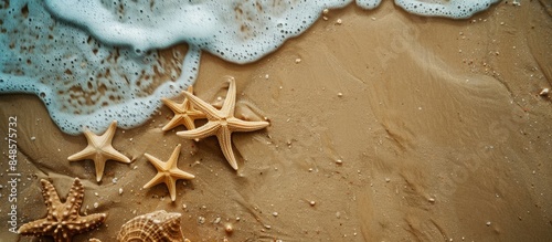 Seashore Summer Vibes: Starfishes Scattered on Sandy Beach Seen from Above with Space for Text