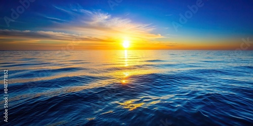 Tranquil cobalt blue ocean reflecting the golden hues of the setting sun with gentle waves , ocean, blue, tranquil, cobalt, sun