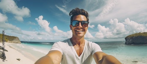 Attractive man capturing a self portrait on vacation with copy space image