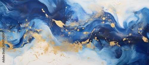 An elegant abstract background using alcohol ink technique featuring indigo blue and gold hues with scattered acrylic blobs and swirling stains suitable for a copy space image